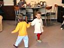 Dancing hand to hand (probably with "Buzzy the Bee" song).